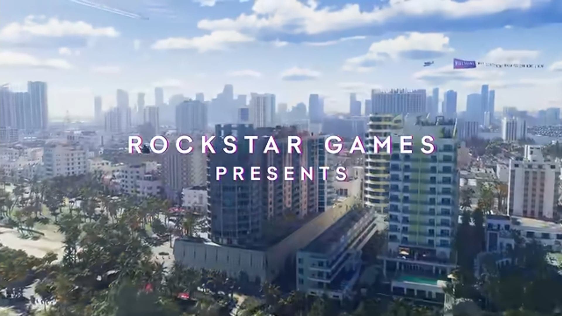 “Rockstar Games presents” over an aerial view of high-rises by the water