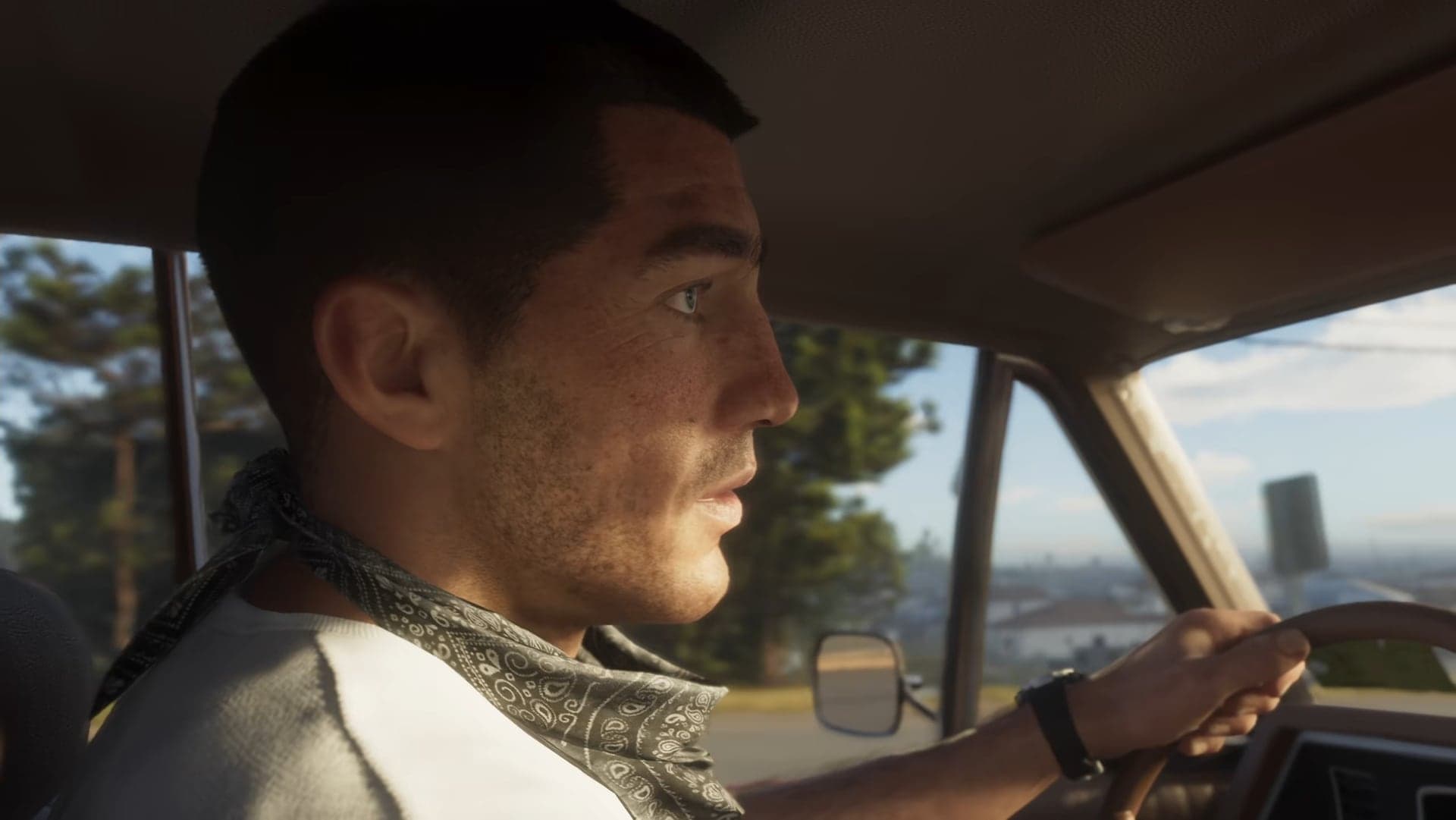A man with a bandana around his neck driving a car