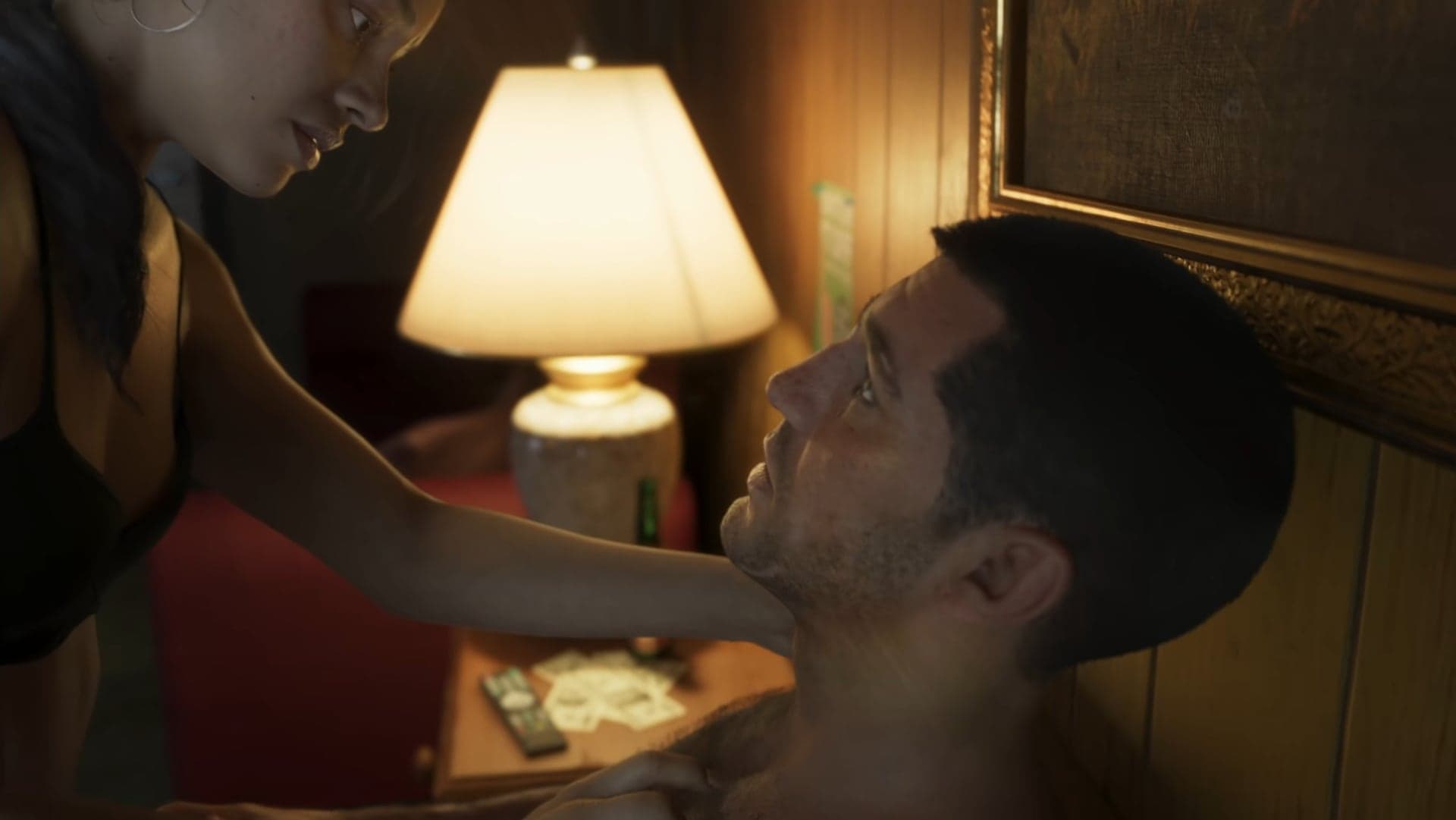 A woman touching a man’s face in a dim room with a lamp