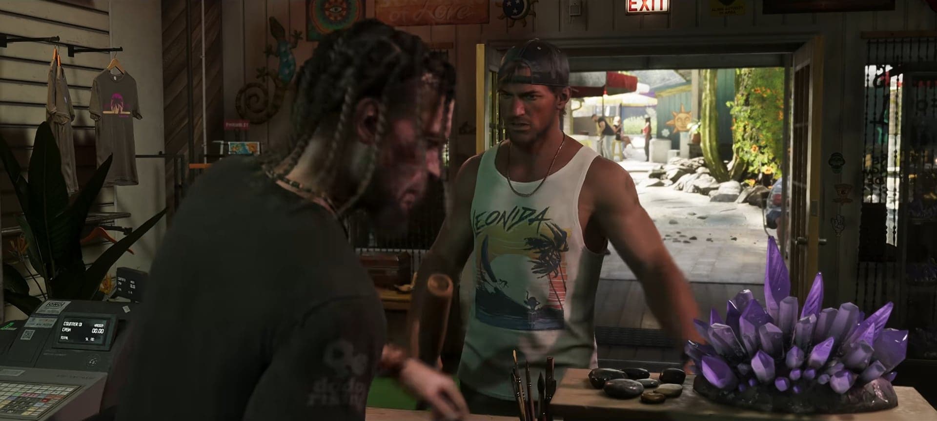 Jason in a cap and tank top at the counter of a crystal shop, with amethyst on the counter