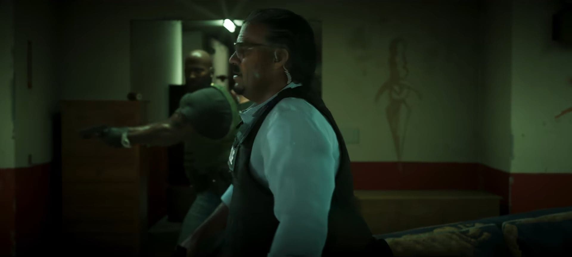 Men with pistols in a dim room with green light