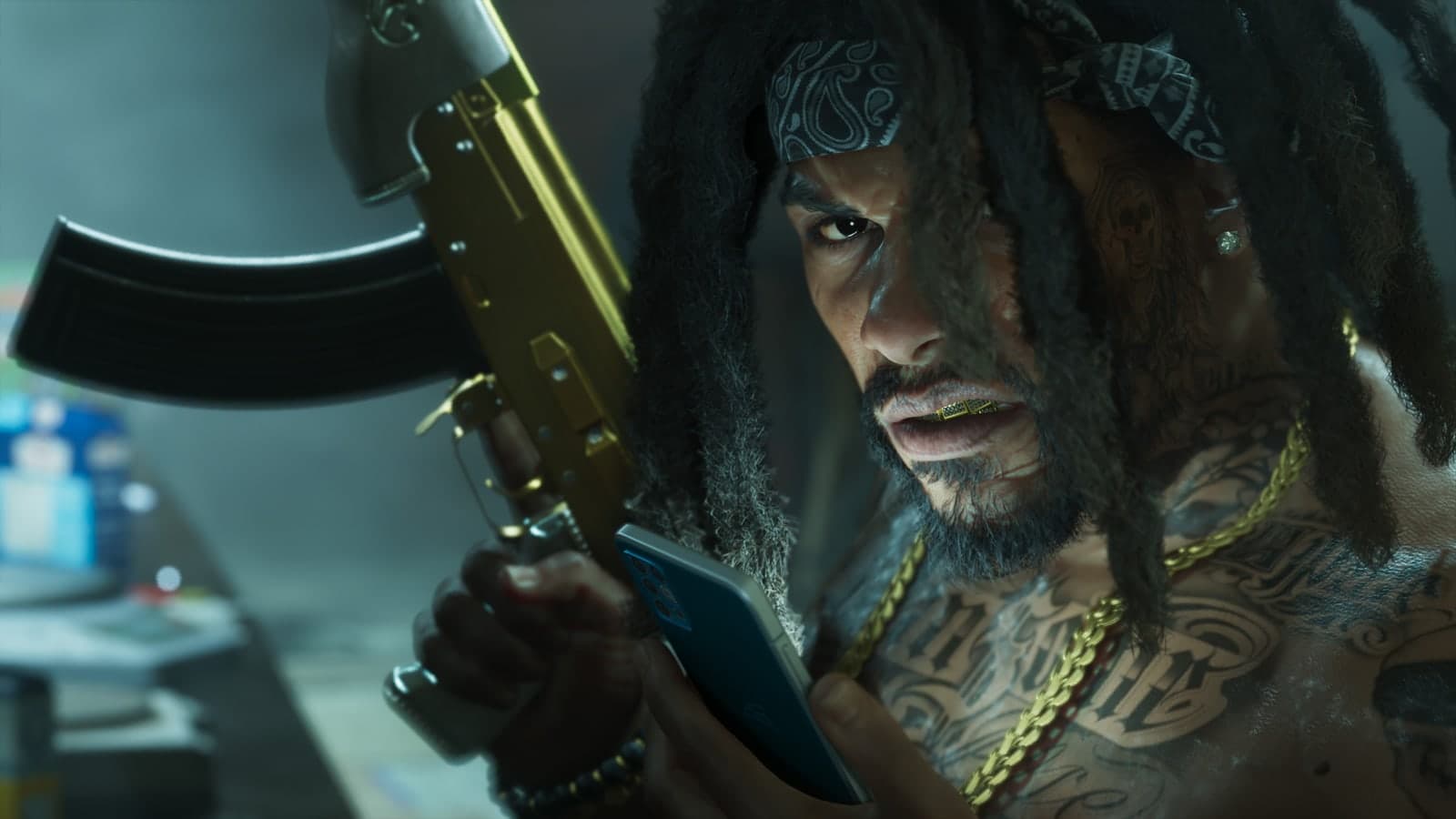 A man with dreadlocks holds a gold AK-style gun and a phone