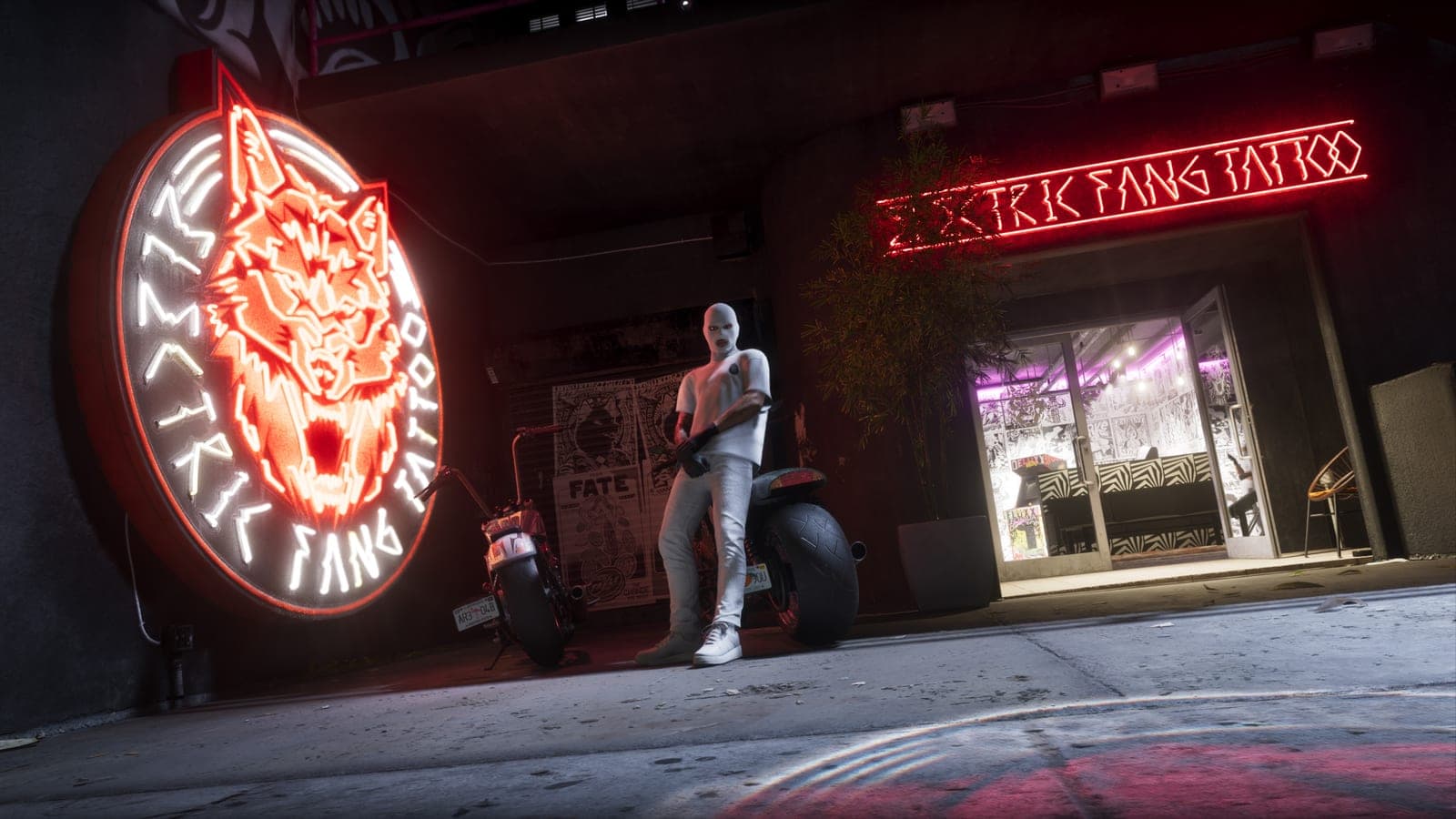 The Electric Fang Tattoo storefront at night with a neon wolf sign