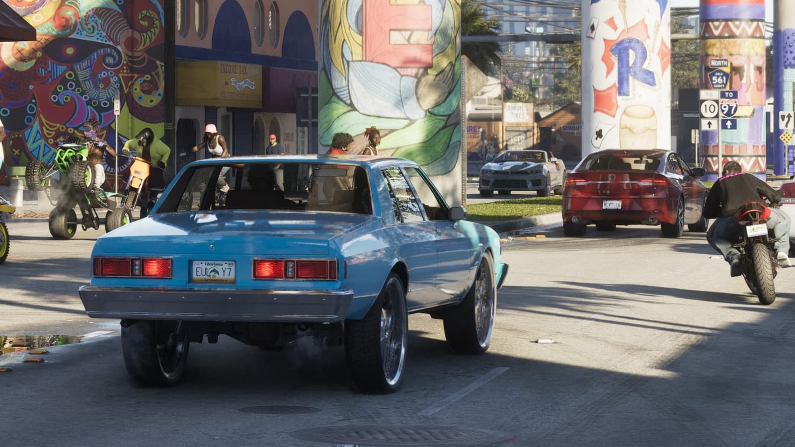 A light blue donk on oversized rims drives past murals under a Vice City overpass